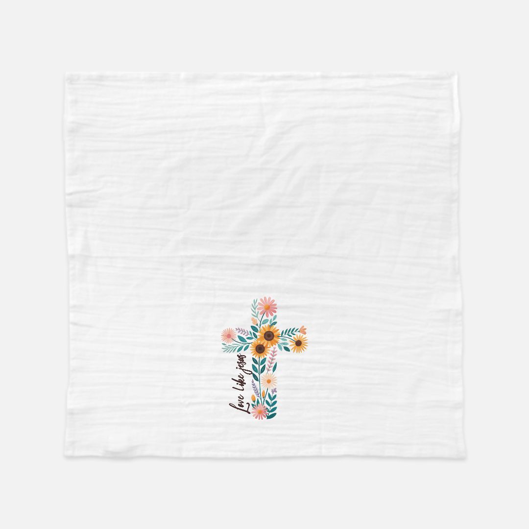 Unfolded tea towel with a Floral cross design on a white background