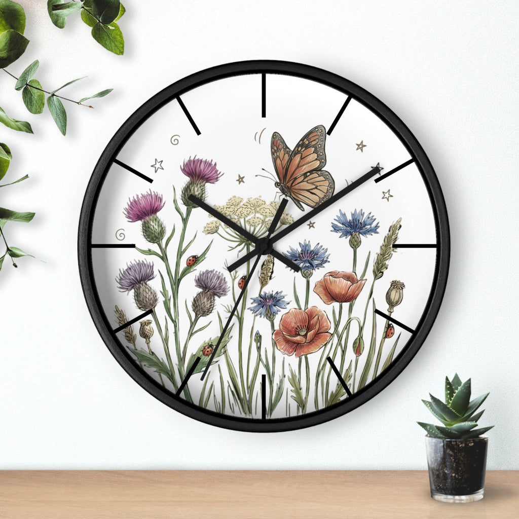 Round black decorative wall clock with floral and butterfly design on a white background