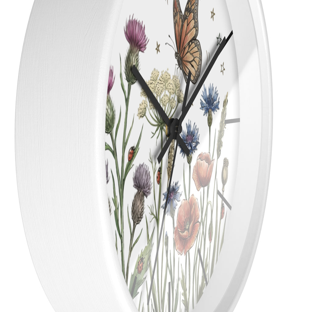 Side view of a round  white wall clock with floral and butterfly design on a white background