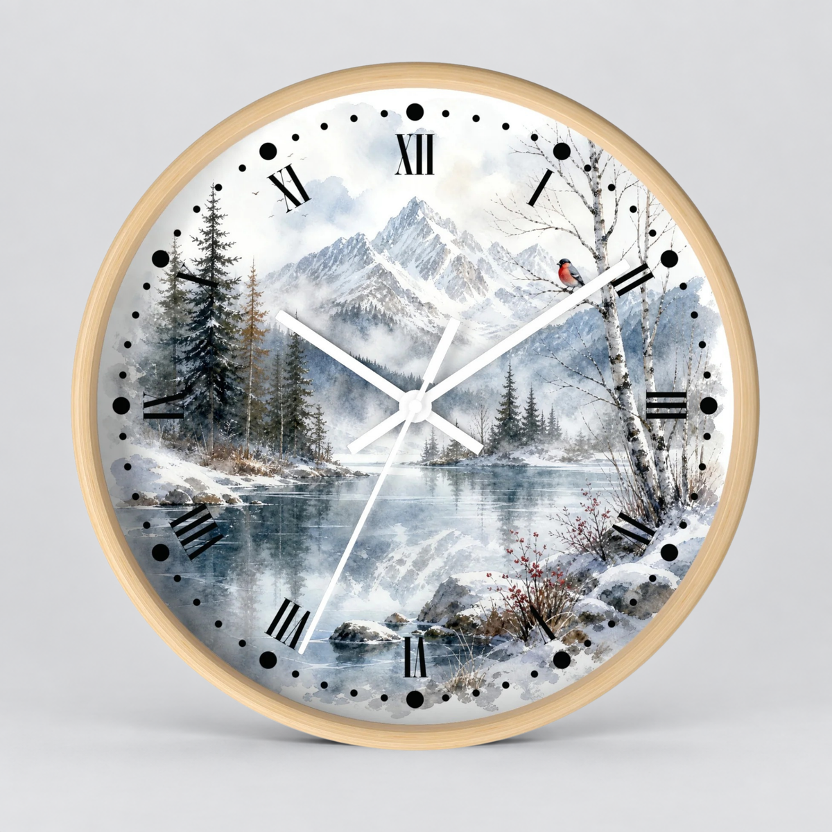 Round wall clock with a light wood frame and a winter landscape print featuring snow-covered mountains, pine trees, a reflective lake, and black Roman numerals on a white background.