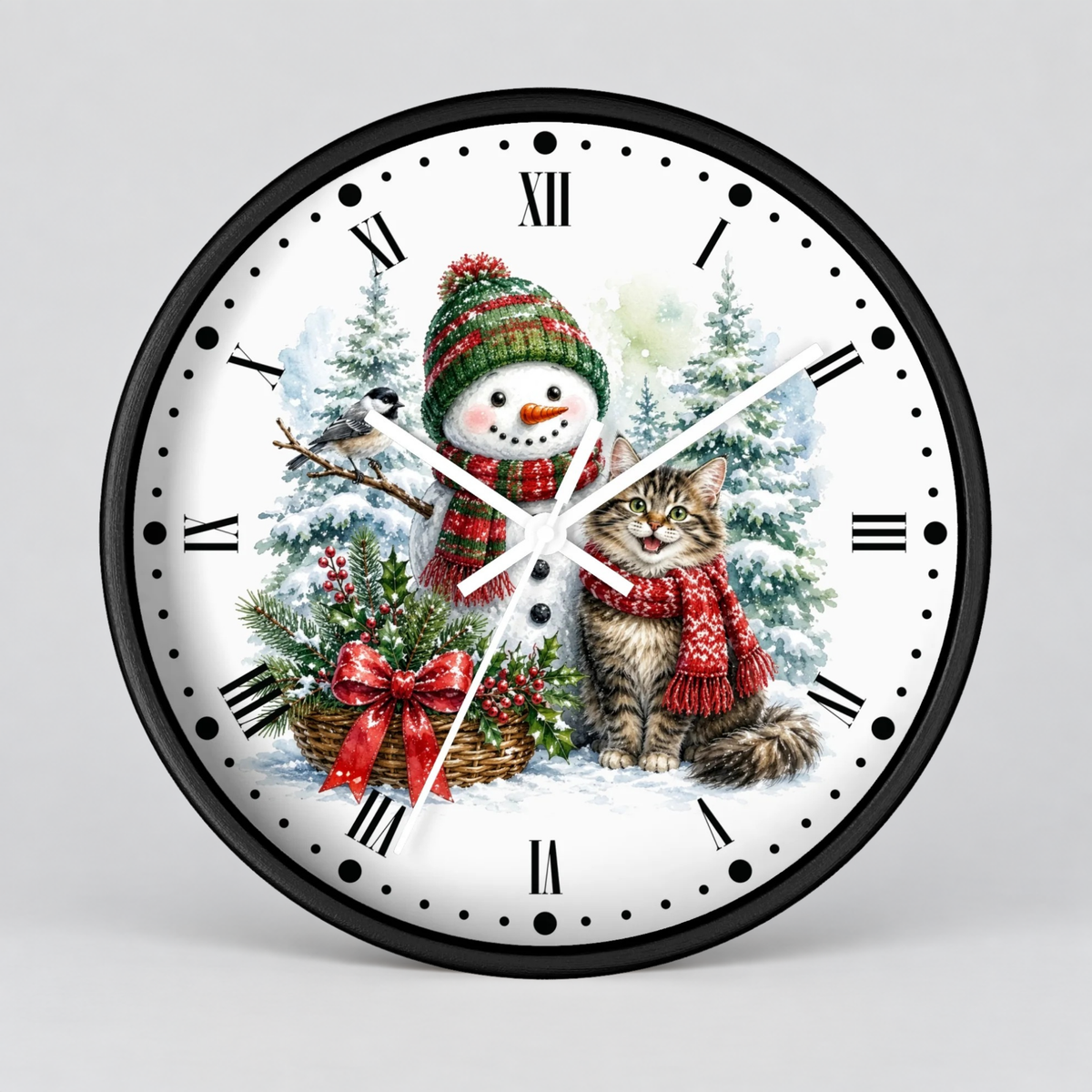 A round wall clock with a black frame and a white face featuring a festive Christmas illustration of a snowman and a cat wearing red scarves, surrounded by snowy trees and a basket of holly, with black Roman numerals and white hands.