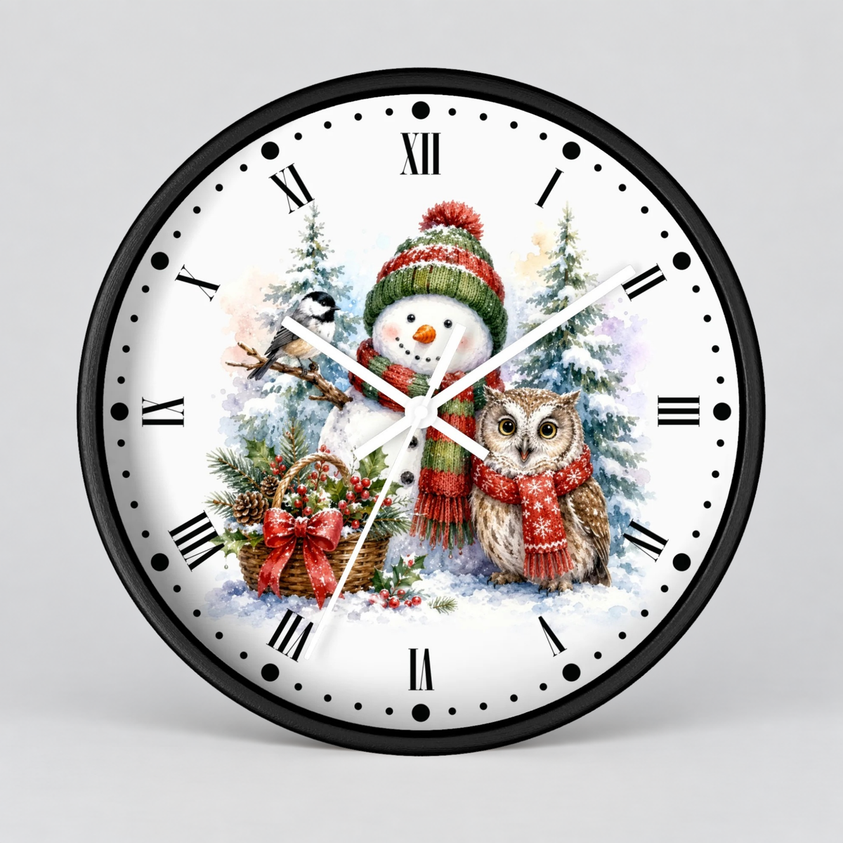 Round wall clock with a black frame and a white face featuring a winter holiday illustration of a snowman in a green and red hat, an owl, pine trees, and a basket, with black Roman numerals and white hands on a light gray background.