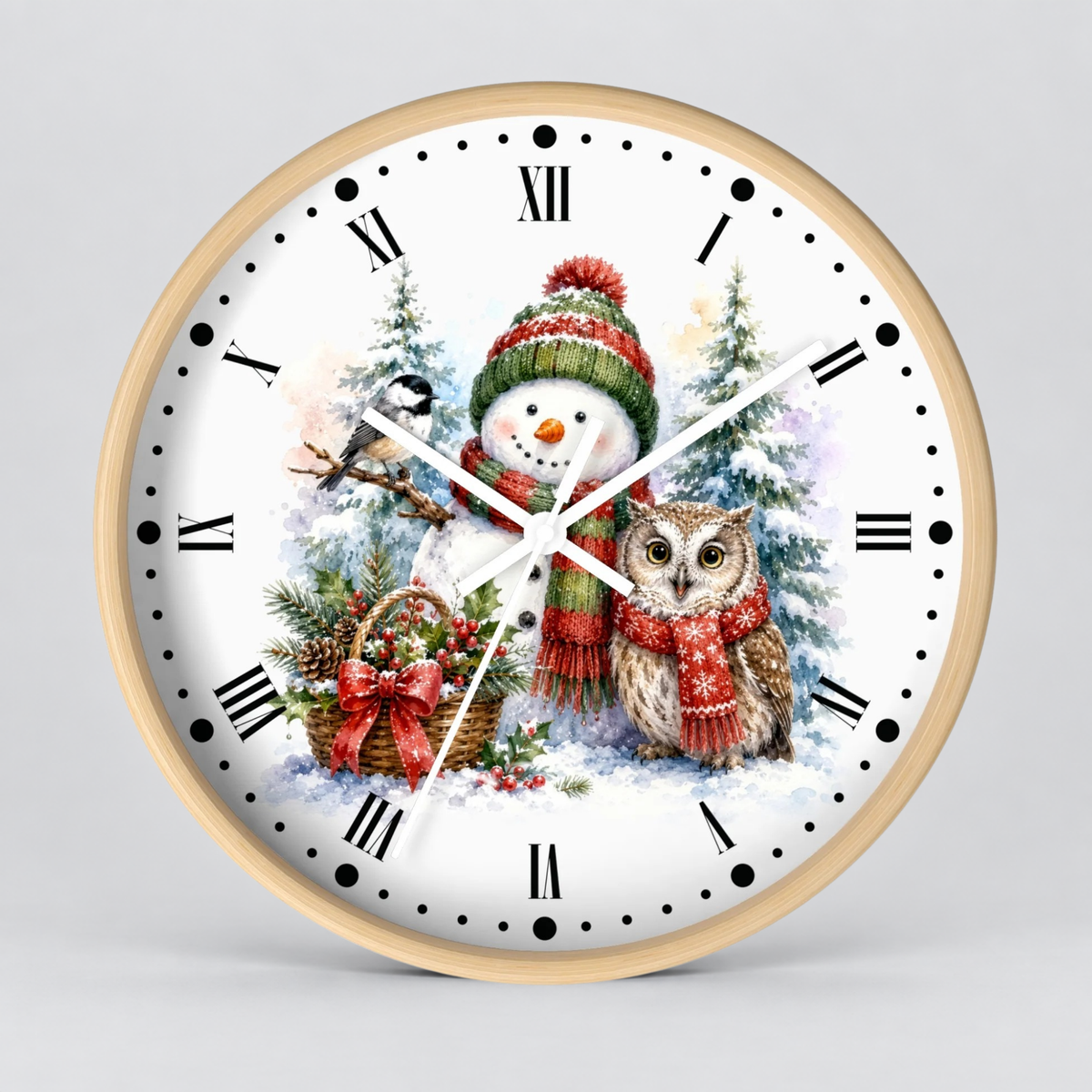 A round wall clock with a light wood frame and a white face featuring a winter holiday illustration of a snowman in a red and green hat beside an owl, with black Roman numerals and hands on a light gray background.
