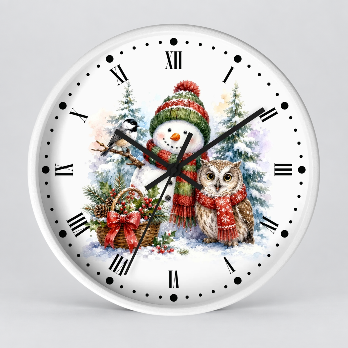 A round white wall clock with black Roman numerals and hands, featuring a festive winter illustration on the face with a snowman in a green and red hat, a brown owl, pine trees, and a basket of ornaments.
