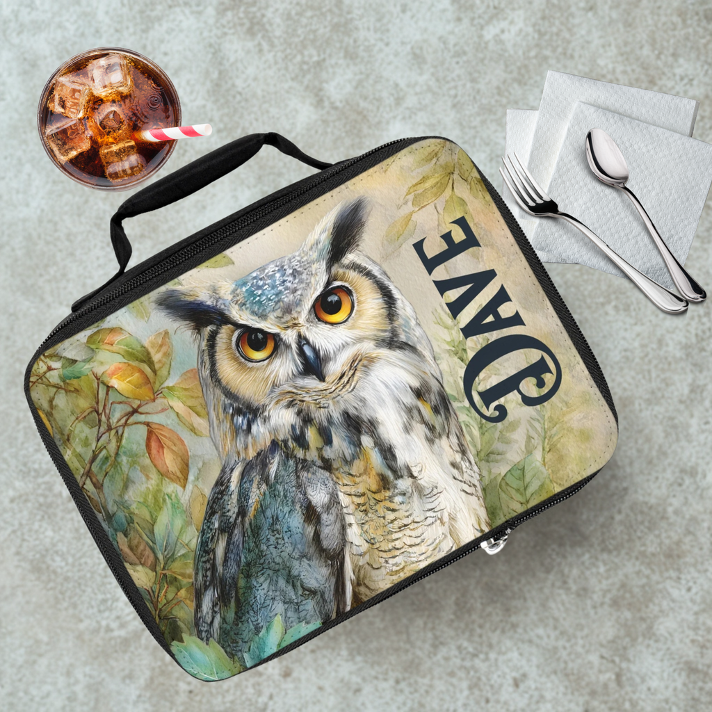 Lunch bag with owl design and 'DAVE' text on a cafeteria table with a drink and utensils.