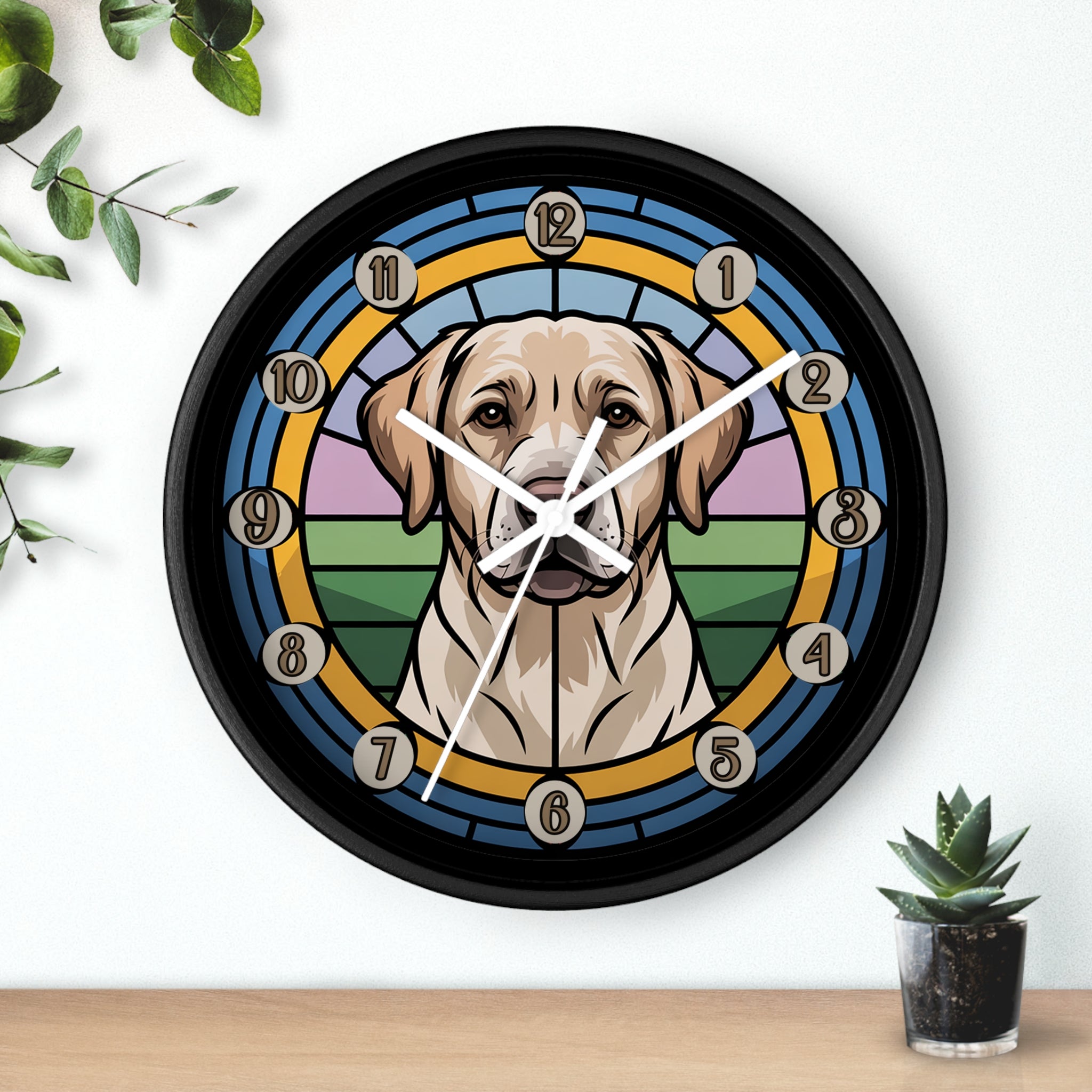 Round black wall clock with a golden lab dog design on a white wall with plants.
