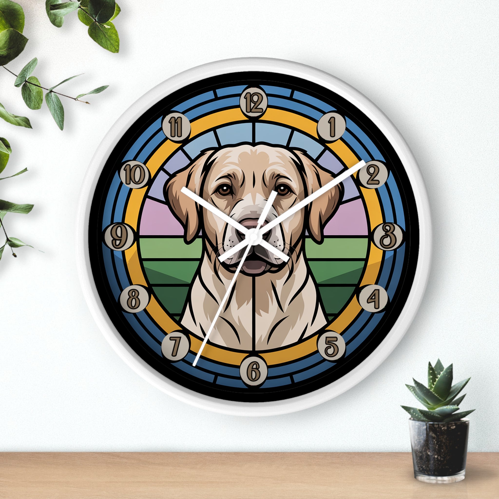 Round white wall clock with a Labrador Retriever dog design on a white wall with plants.