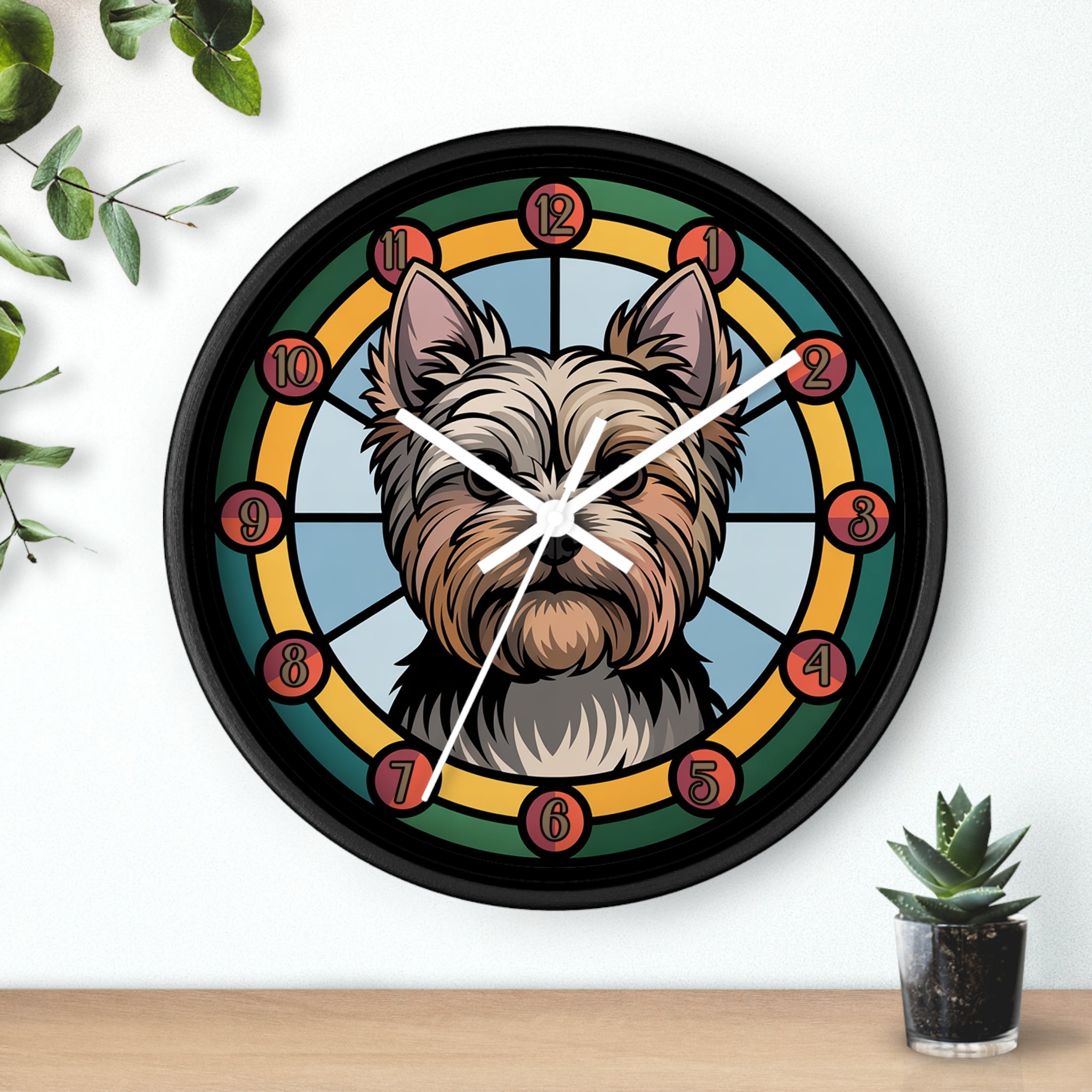 Round black wall clock with a Yorkie dog's face design on a white wall with plants.