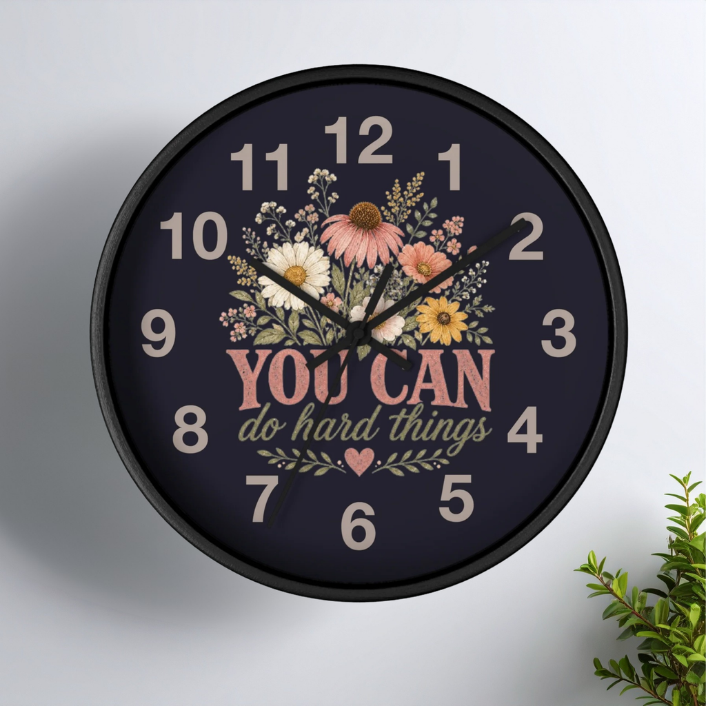 Wall clock with floral design and motivational quote on a white background
