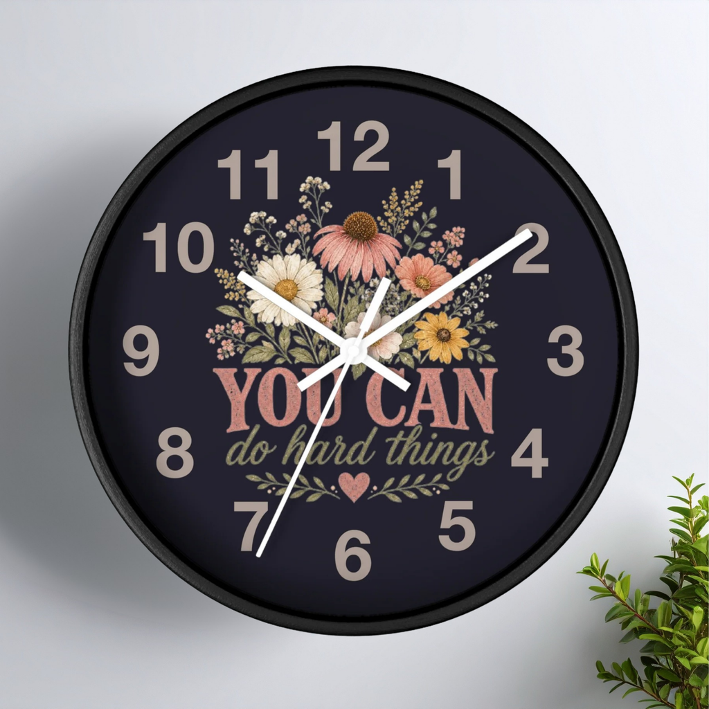 Decorative wall clock with floral design and motivational quote on a white background