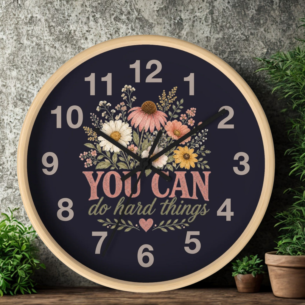 Decorative clock with floral design and motivational quote on a dark background