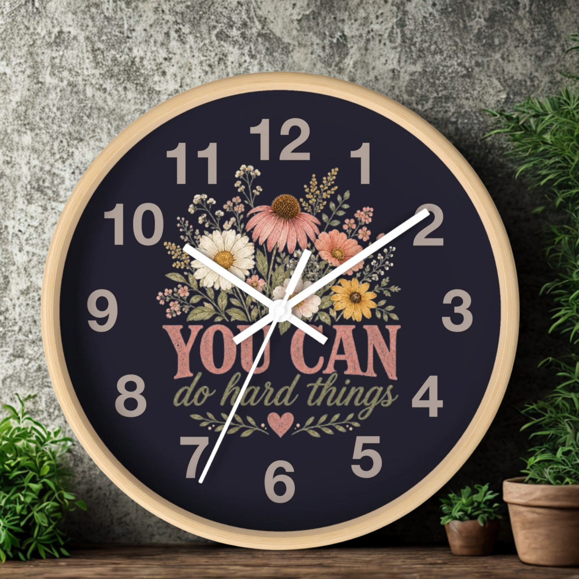 Decorative clock with floral design and motivational quote on a dark background