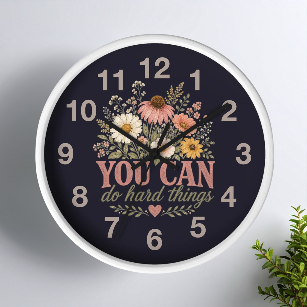 Wall clock with floral design and motivational quote on a white background