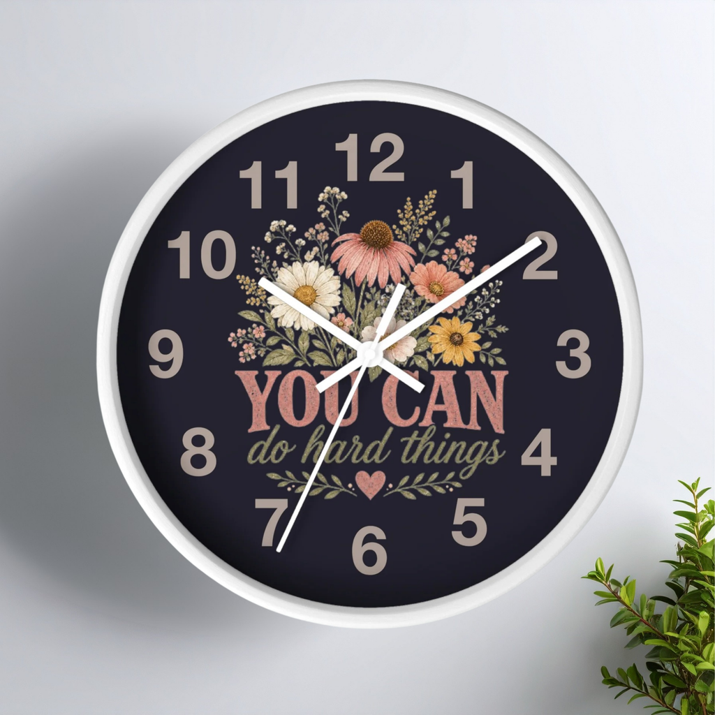Wall clock with floral design and motivational quote on a white background