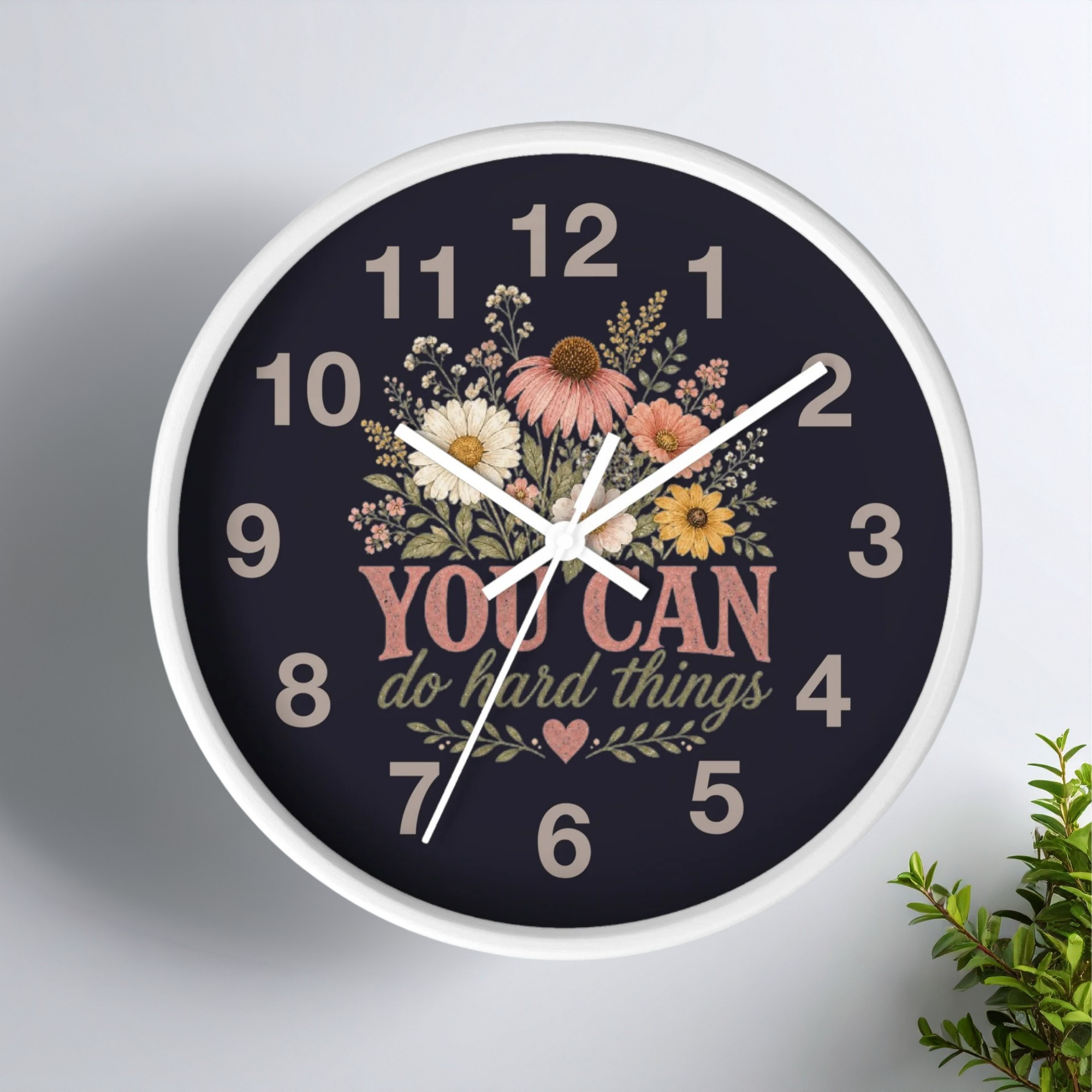 Wall clock with floral design and motivational quote on a white background