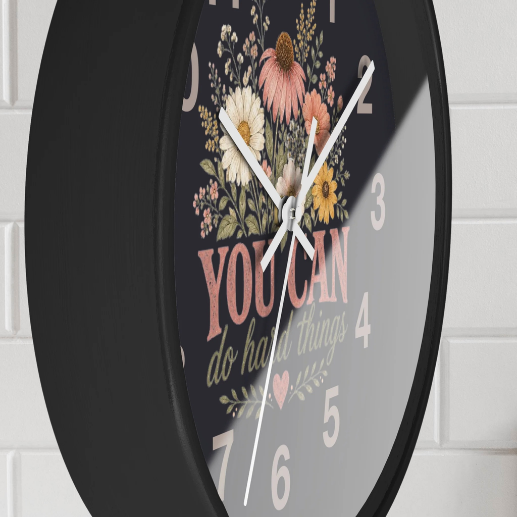 Wall clock with floral design and motivational quote on a white brick wall background
