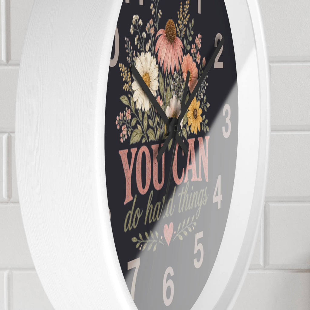 Decorative wall clock with floral design and motivational quote on a white background