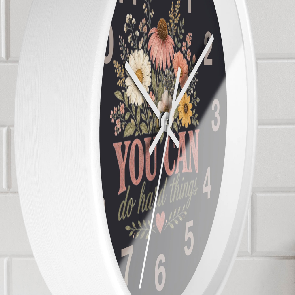 Decorative wall clock with floral design and motivational quote on a white background