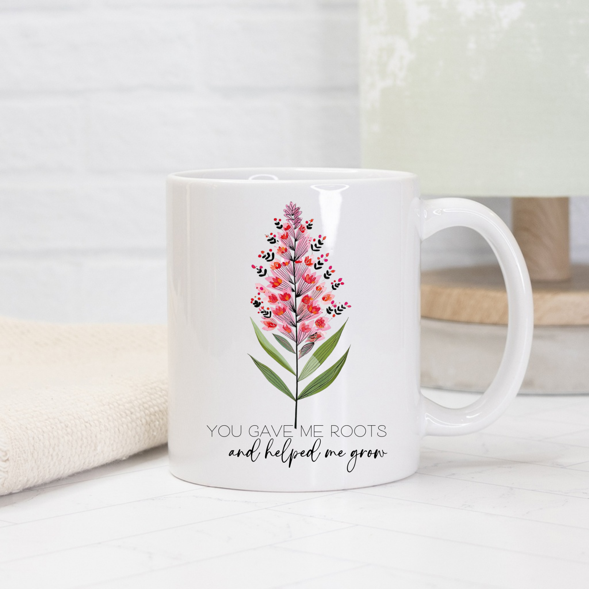 White 11oz mug with floral design and text on a light background