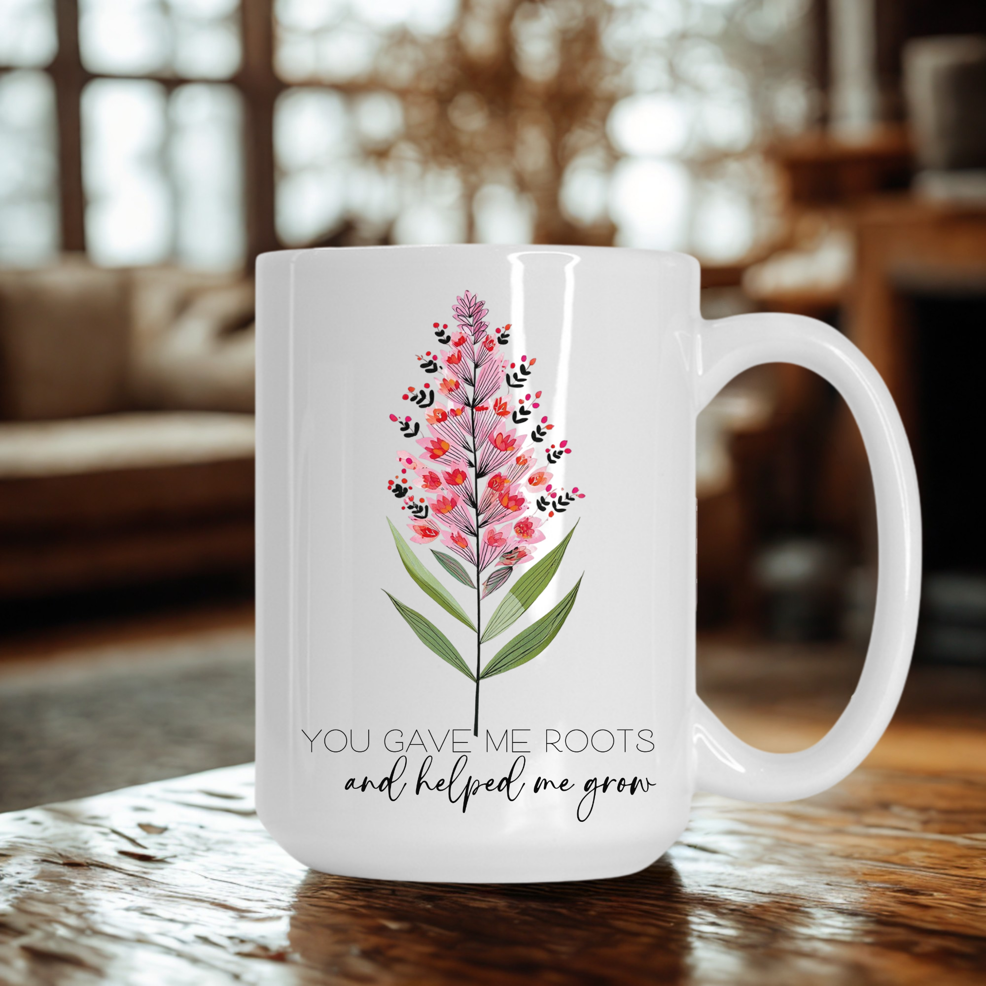 White 15oz mug with floral design and text on a wooden table