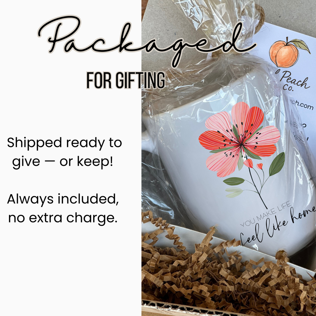 White 15oz. mug with floral design and text, wrapped in clear plastic in side a white gift box with brown tissue paper, ready for gifting.