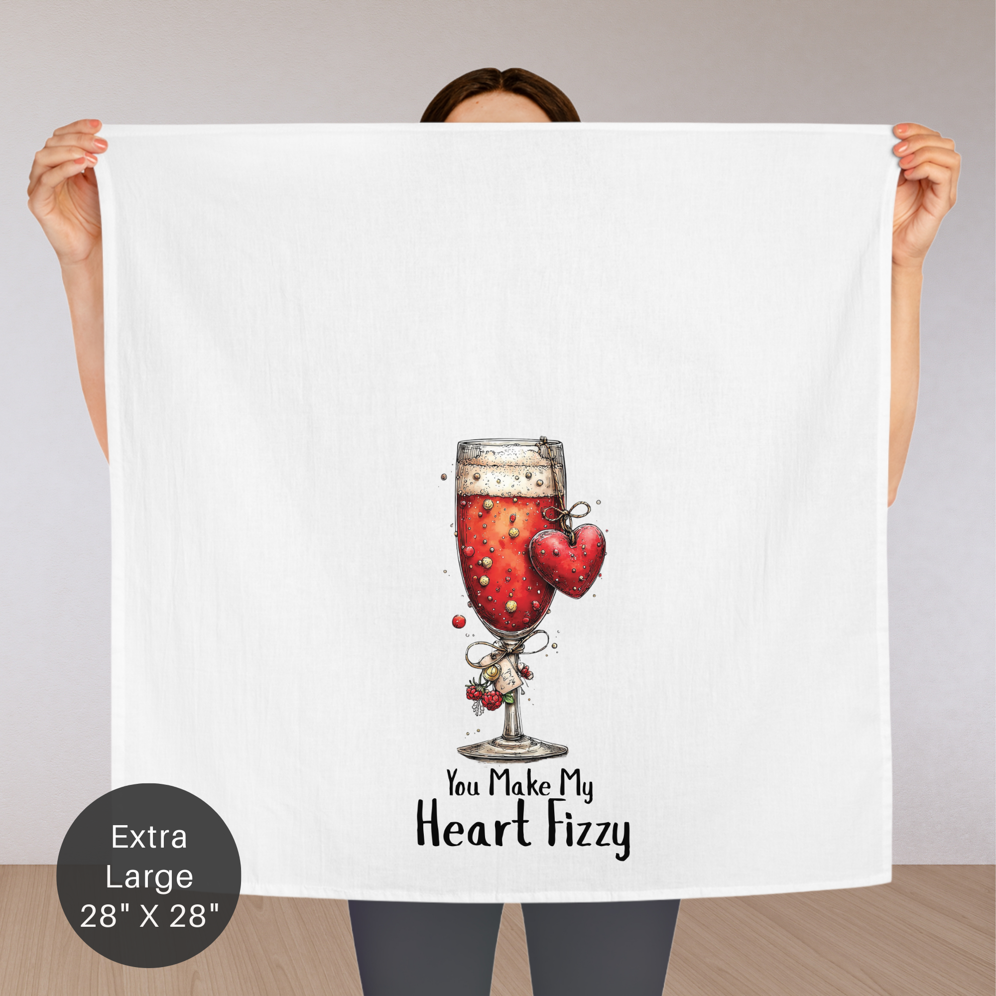 Person holding a large poster with a glass of red wine and hearts, text 'You Make My Heart Fizzy', and an extra large label on a neutral background.