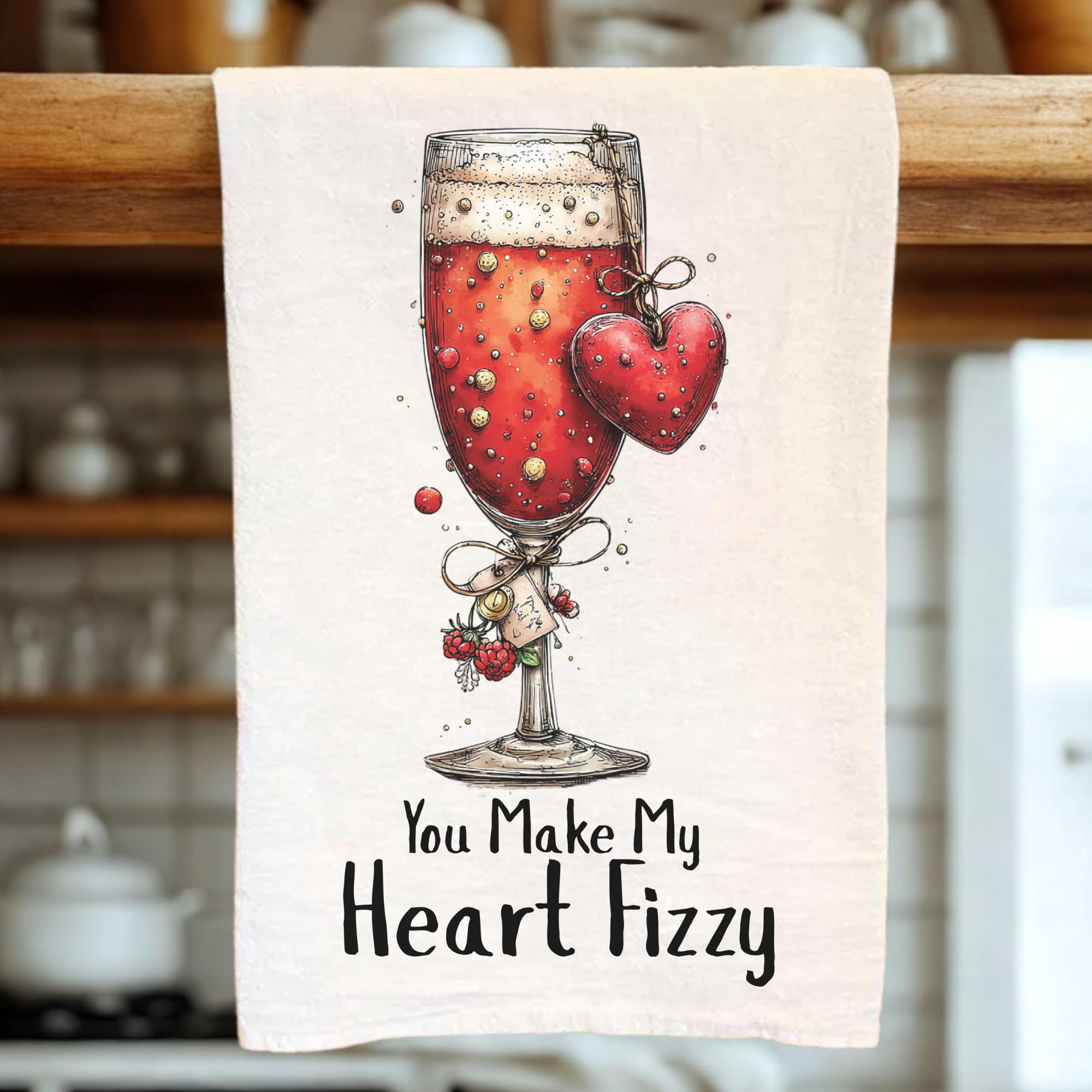 Towel with a glass of red wine and heart design, text 'You Make My Heart Fizzy' on a kitchen towel.