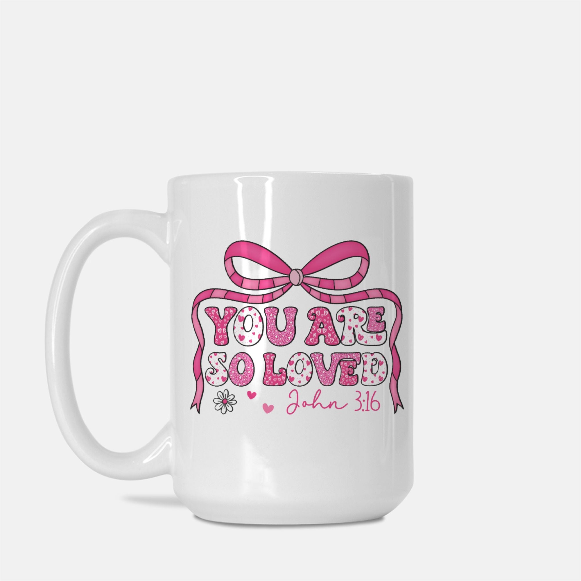 White mug with pink bow and text design on a white background