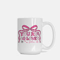 White mug with pink bow and text 'You are so loved John 3:16' on a white background