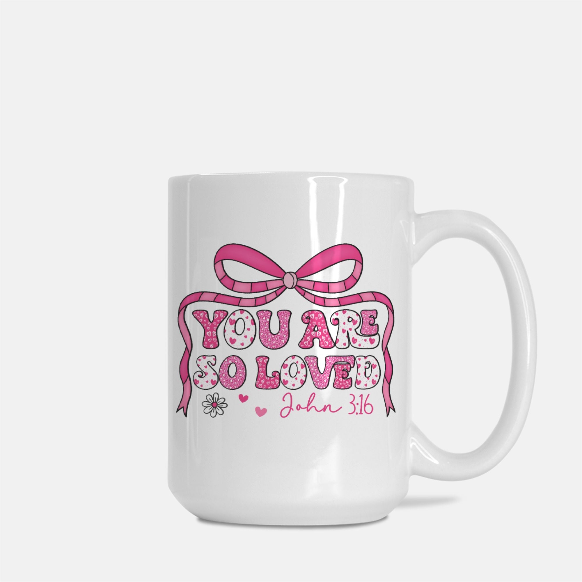 White mug with pink bow and text 'You are so loved John 3:16' on a white background