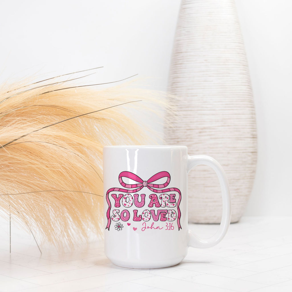 White mug with pink design and text on a white background