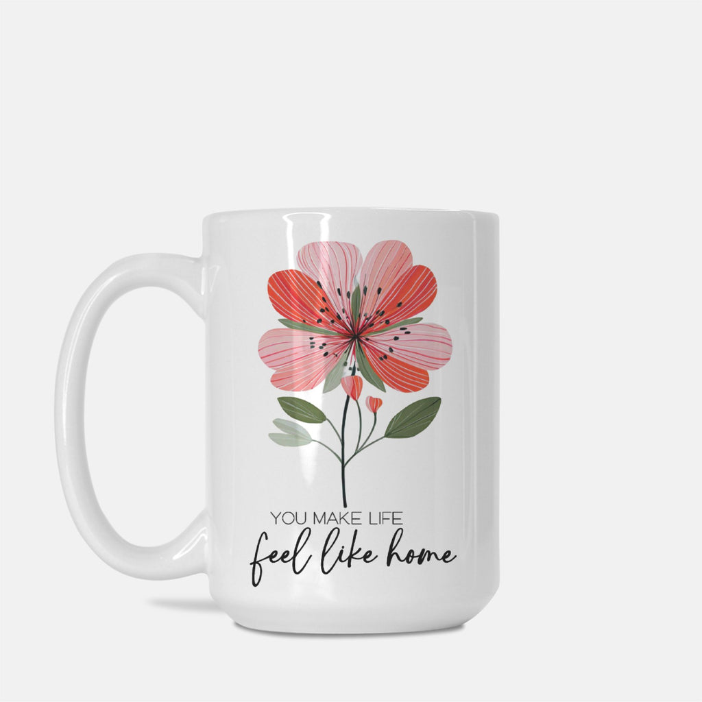 White 15oz. mug with a pink floral design and text 'You Make Life Feel Like Home' on a white background