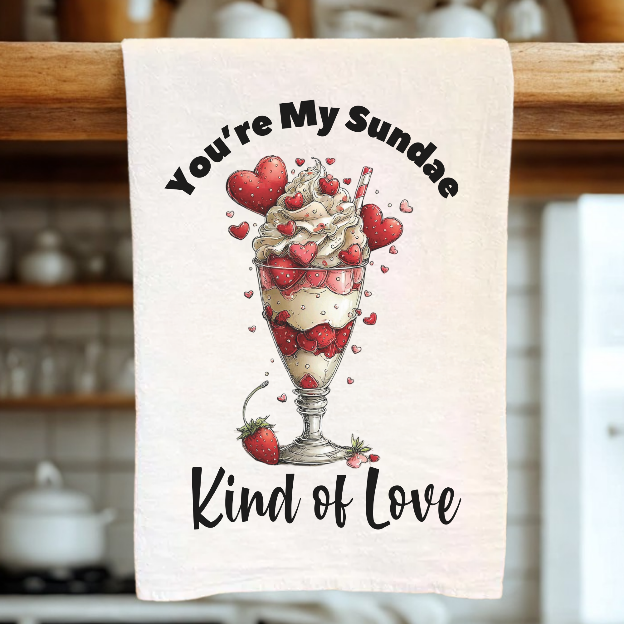 Tea towel with a dessert illustration and text in a kitchen setting