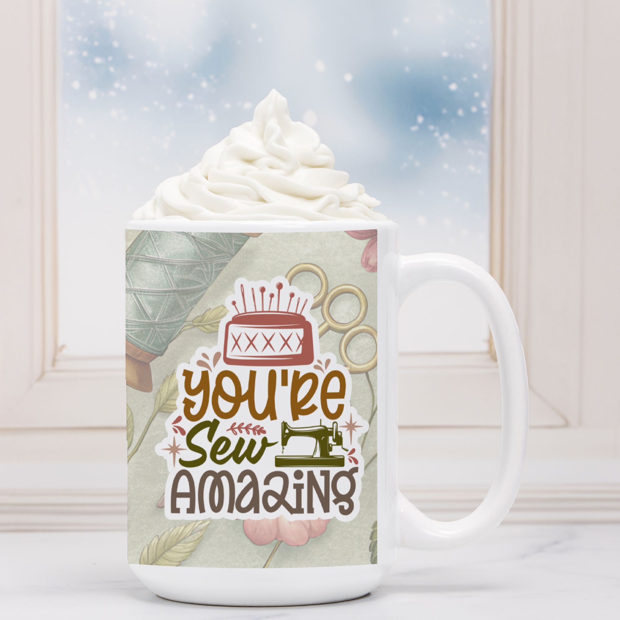 White mug with 'You're Sew Amazing' design on a snowy background