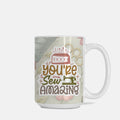 Mug with 'You're Sew Amazing' text and sewing-themed design on a light background