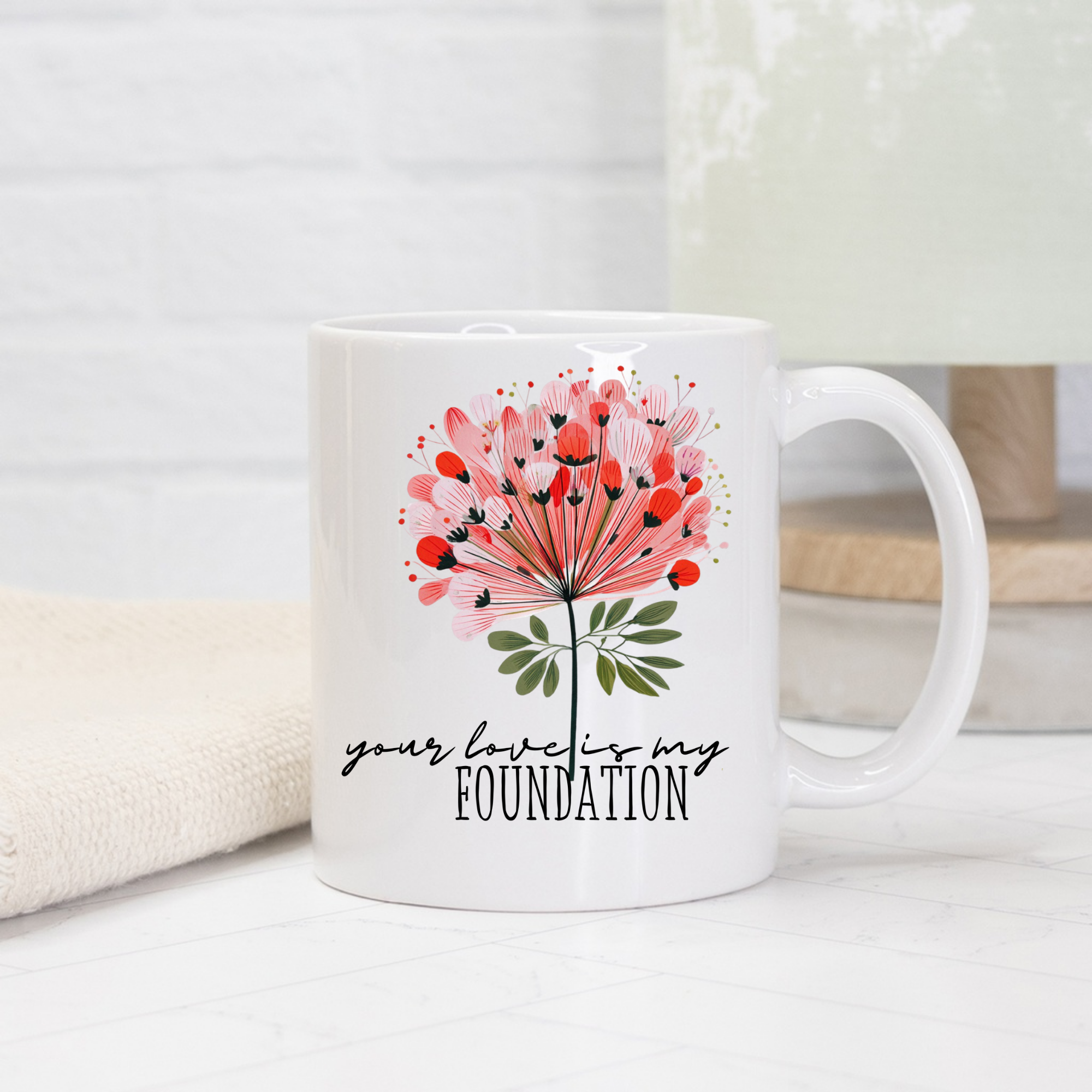 11oz white ceramic mug with floral design and text 'your love is my foundation' on a light background