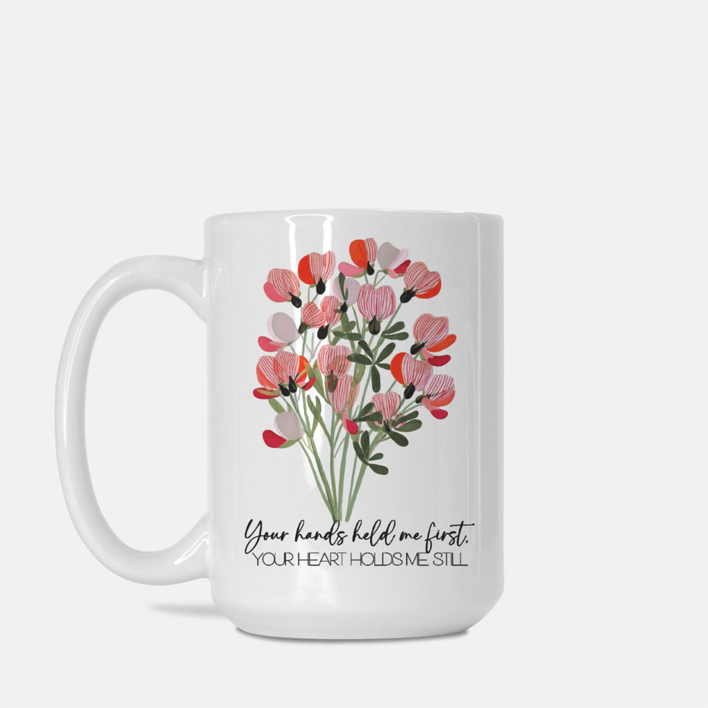 White mug with floral design and text on a white background