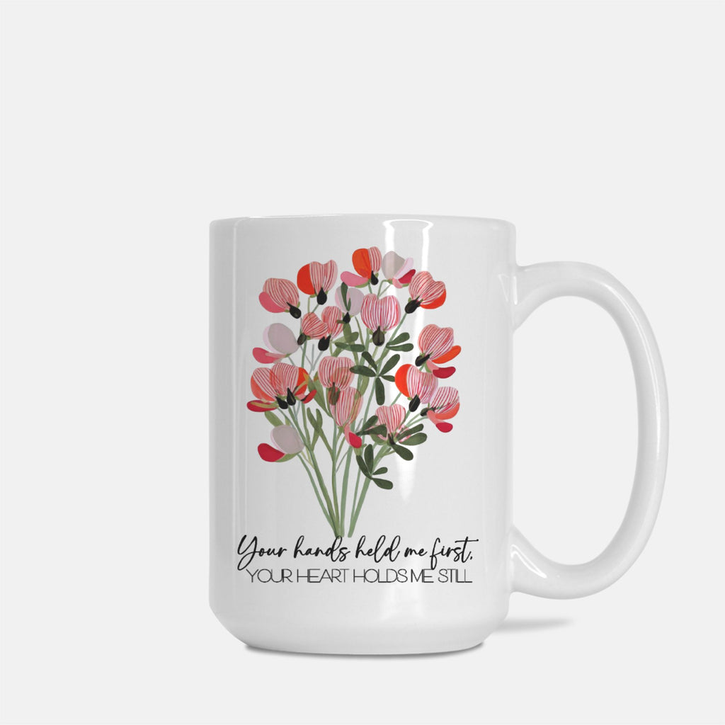 White mug with floral design and text on a white background