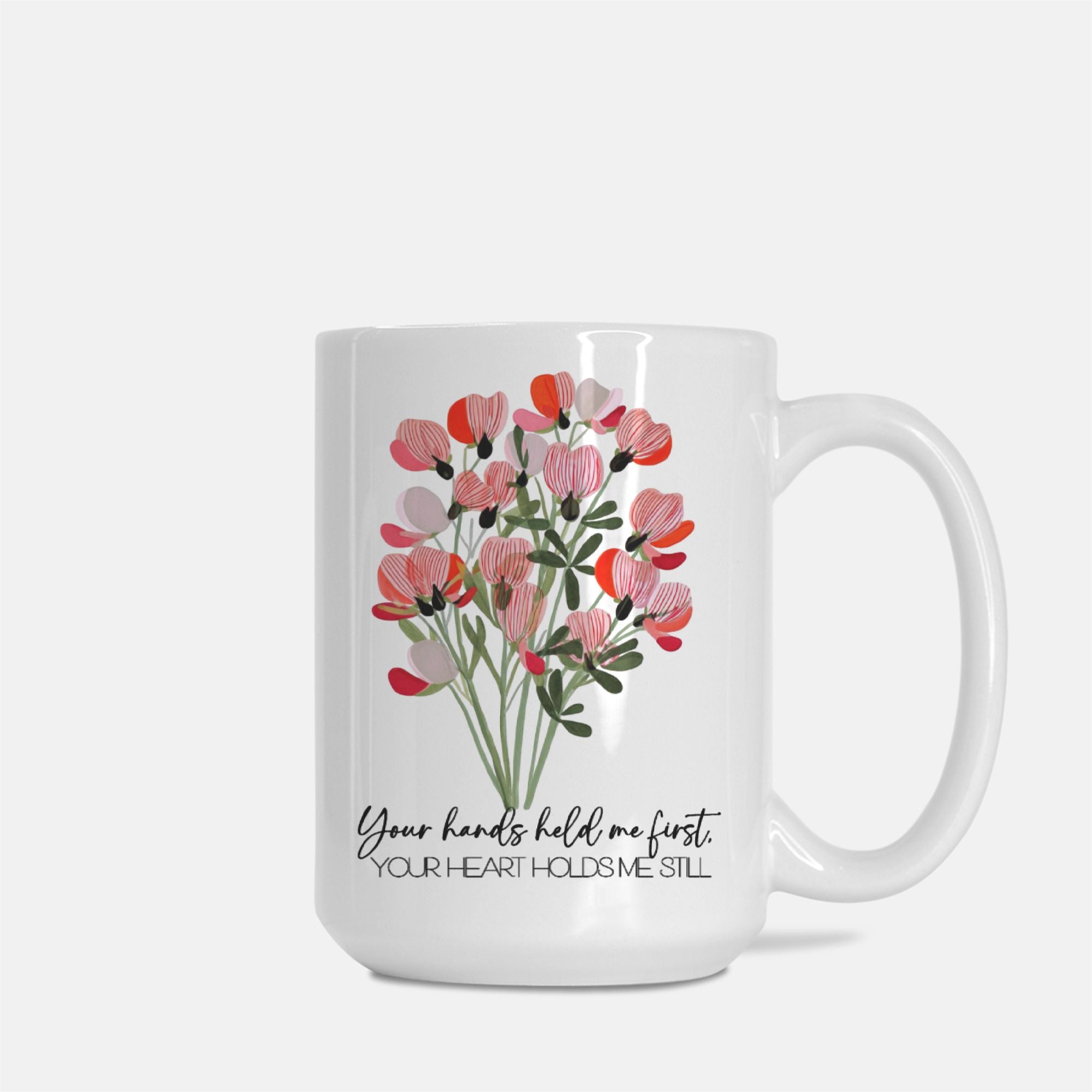White mug with floral design and text on a white background
