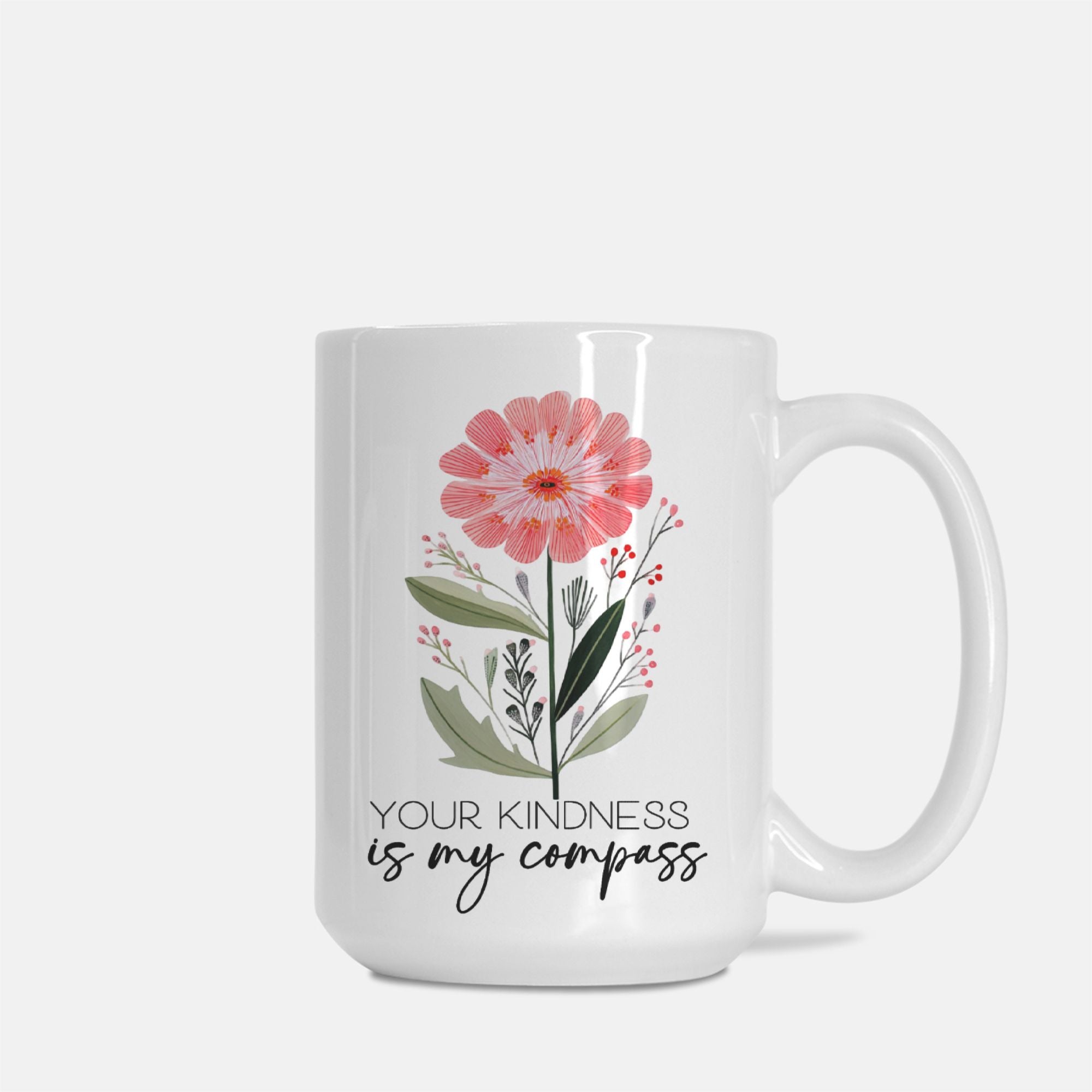 White 15oz mug with floral design and text 'Your kindness is my compass' on a white background