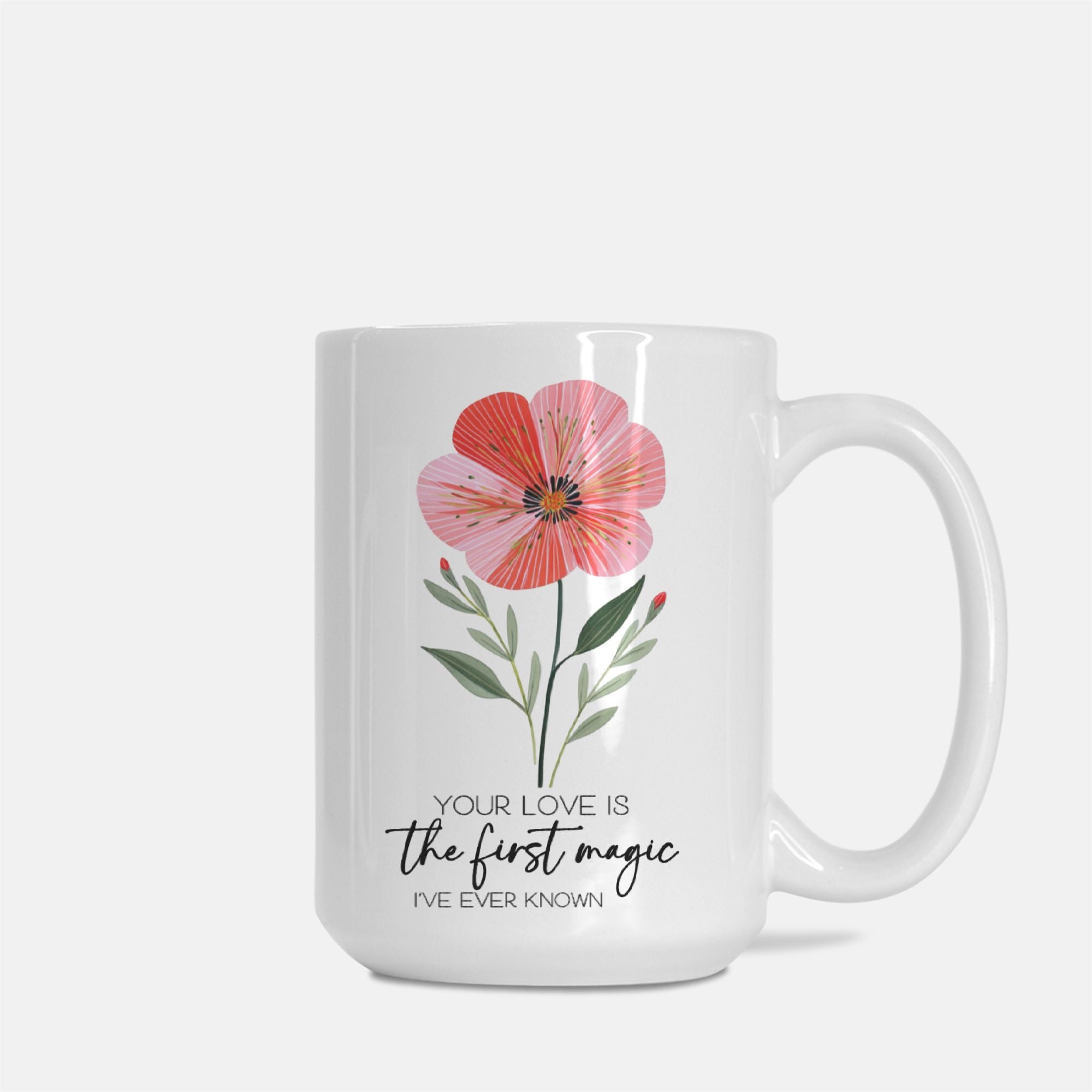 White mug with a pink flower design and text on a white background