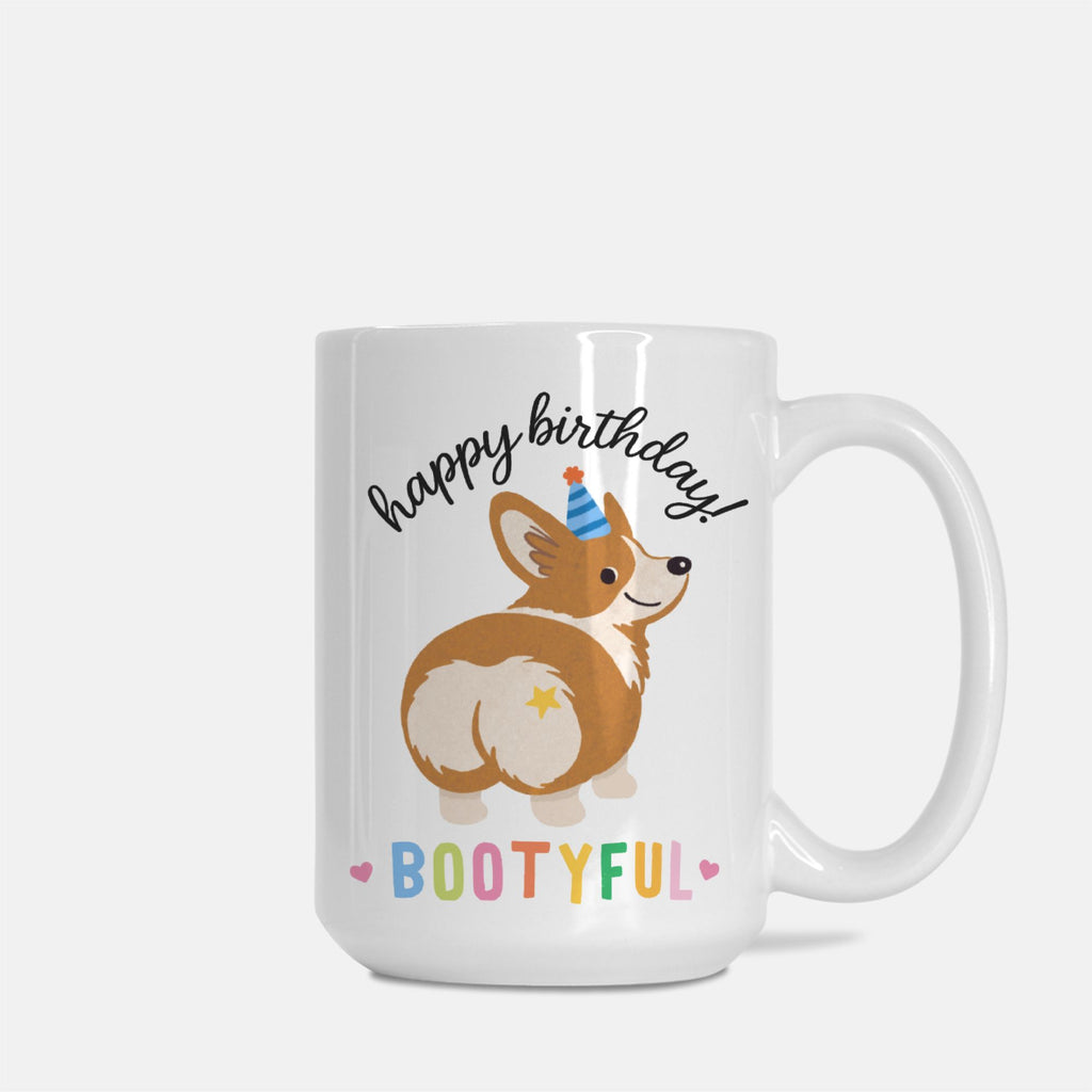 White mug with a corgi illustration and 'happy birthday bootyful' text on a white background