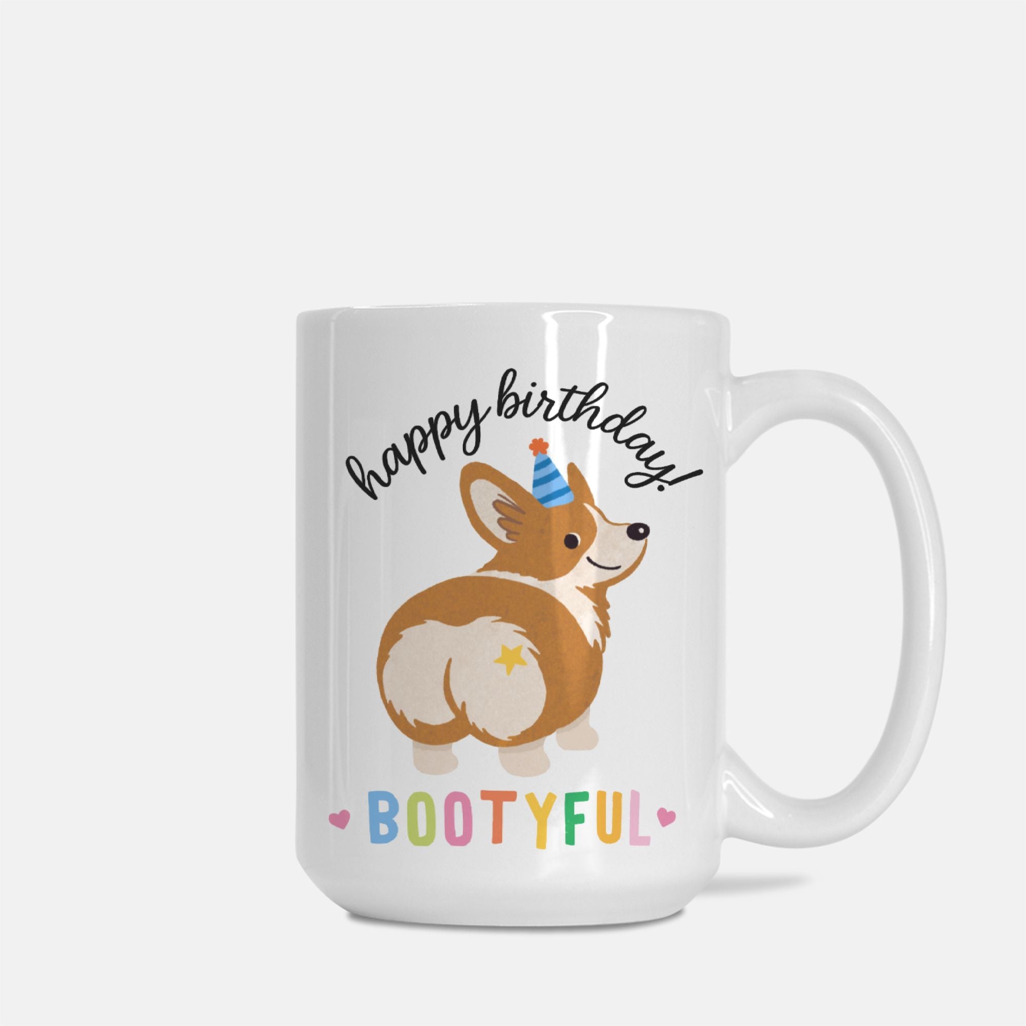 White mug with a corgi illustration and 'happy birthday bootyful' text on a white background