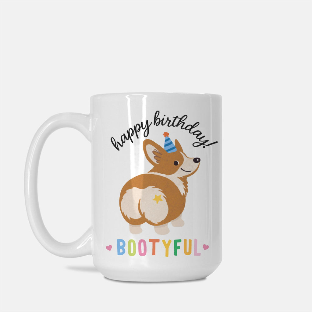White mug with a corgi design and 'happy birthday bootyful' text on a white background