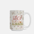 Mug with 'Life's a Stitch' text and floral patterns on a white background