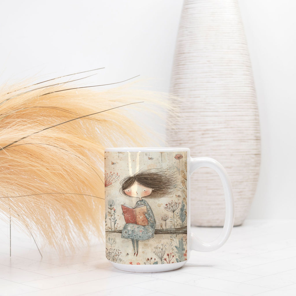 Mug with a design of a girl reading a book, placed on a light surface with decorative elements.