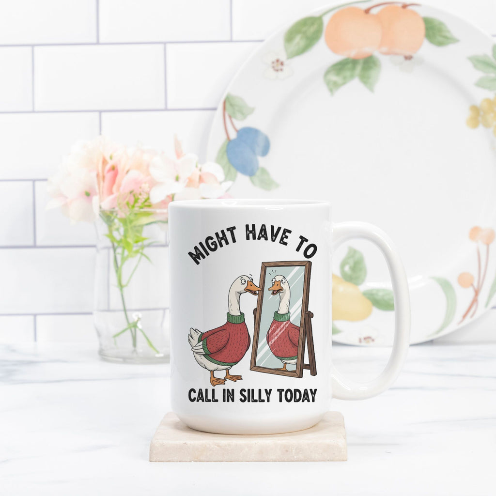 Mug with goose illustration and text on a kitchen counter with a plate and flowers in the background