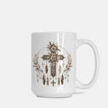 White mug with a decorative cross and feather design on a white background