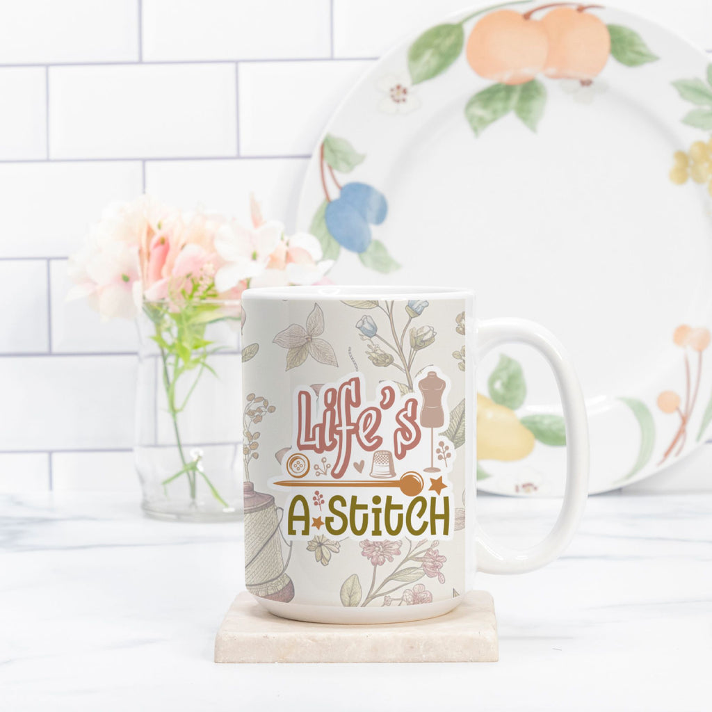 Mug with 'Life's a Stitch' design on a white surface with a decorative plate in the background.