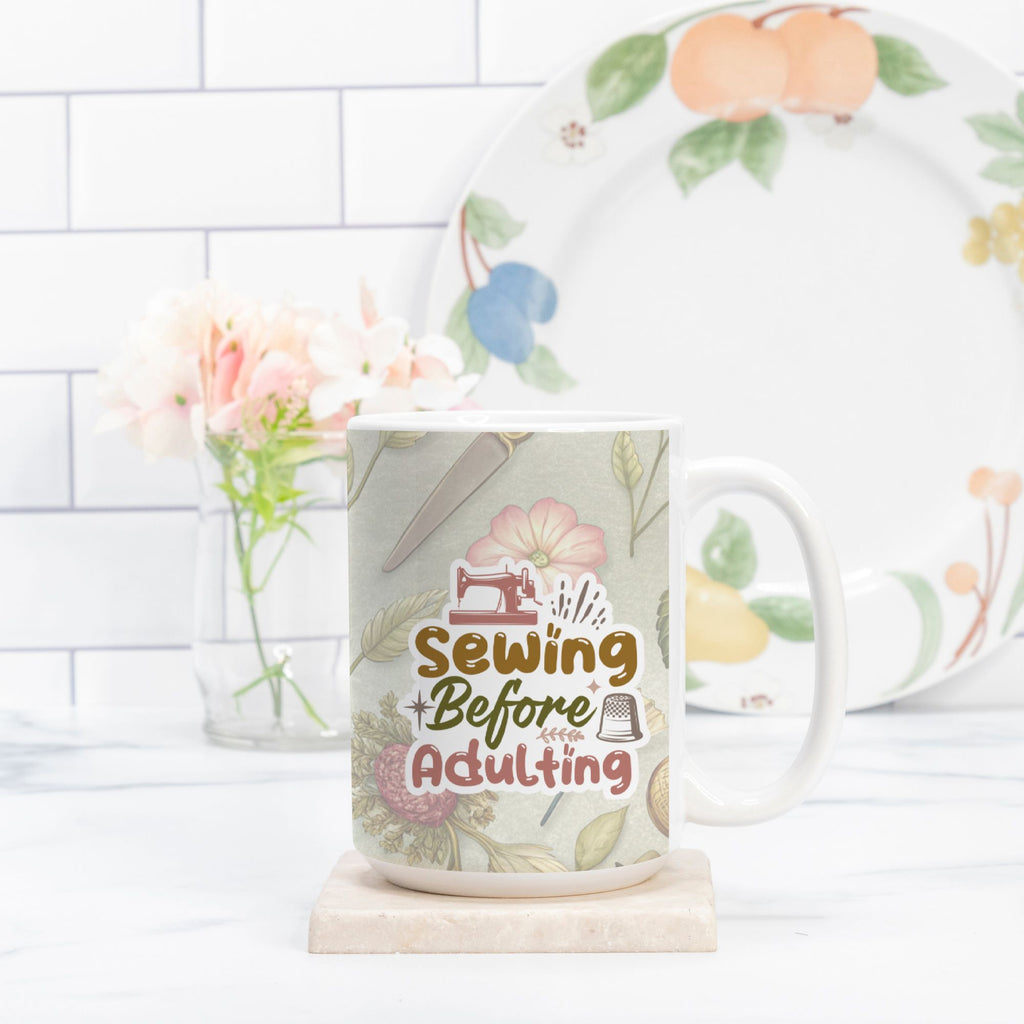 Mug with 'Sewing Before Adulting' design on a white surface with a floral arrangement in the background.